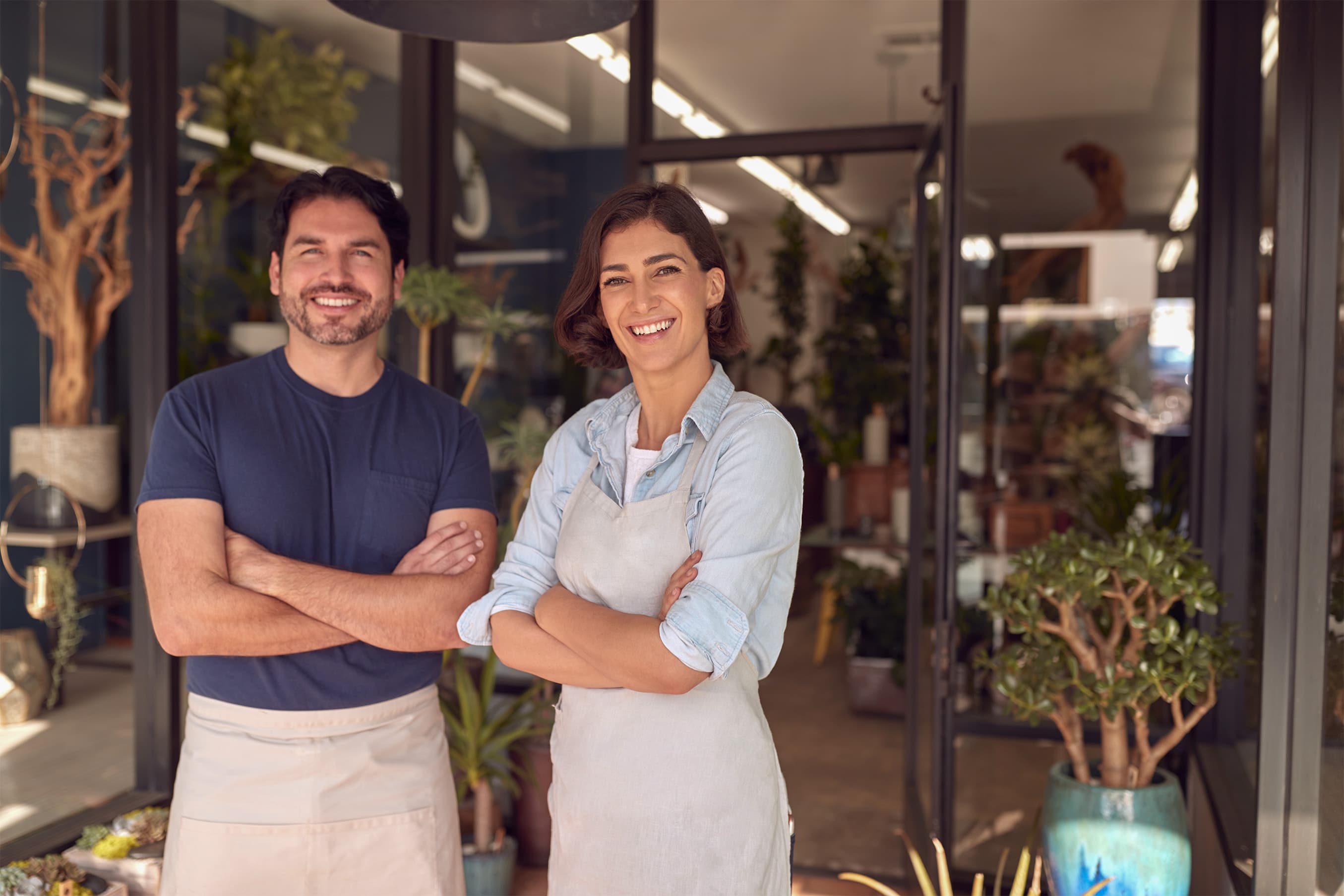 A local business owner speaking with a customer at the counter of a bright neighbourhood studio